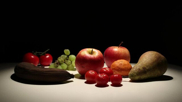 Fruit decomposition time lapse with black background, static shot