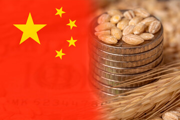 Chinese flag on grain background with coins close up. Export of wheat and grain. World food crisis....