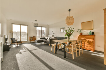 a living room with a dining table and two couches in the room is empty, but there is no one