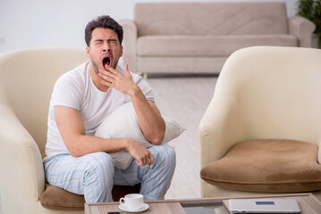 Young man starting day at home