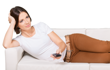 Woman Lying on the Couch Using a Remote Control