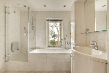 a bathroom with a tub, sink and shower stall in the same room on the other side of the bathtub