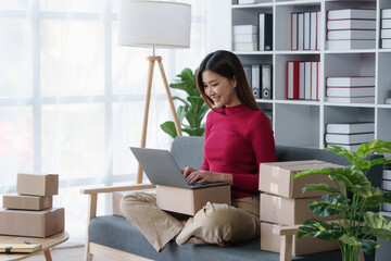 Small businesses SME owners female entrepreneurs check online orders to prepare to pack the boxes,...