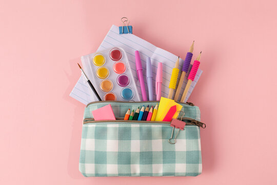 Stylish stationery in a pencil case on a pink background. Back to School 