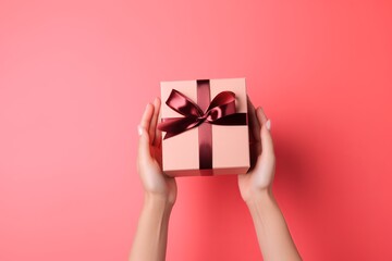 Hands holding open gift box with red bow on pink back from generative ai