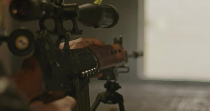 Sniper firing a shot with a scoped FN FAL combat rifle