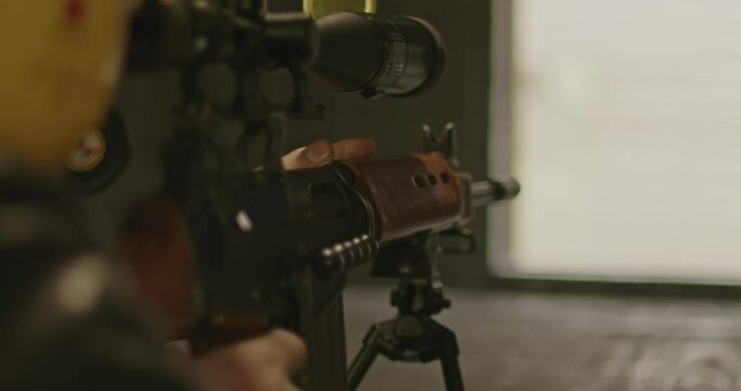 Sniper aiming a FN FAL Combat rifle from the inside to an unseen outside target