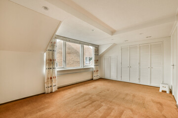 an empty room with white shutters on the walls and doors in the corner to the room is very clean