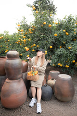 Lady tourist travel at organic tangerine farm in Jeju Island, Korea.