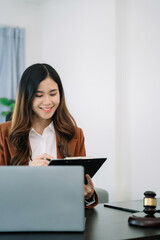 Lawyer office. gavel of Justice with scales and lawyer working on a laptop. Legal law, advice and justice concept.