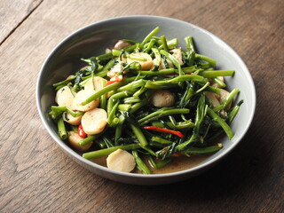 stir fried water spinach with garlic, chili and fish balls