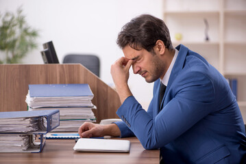 Fototapeta premium Young male employee working in the office