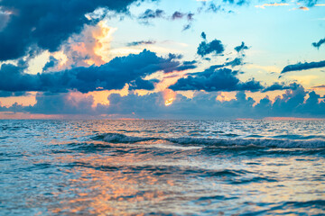 Fototapeta na wymiar Cloudy sky on sea sunset, sunrise on ocean beach. Sunset landscape in the sky after sunset. Sunrise with clouds of different colors against the sky and sea.