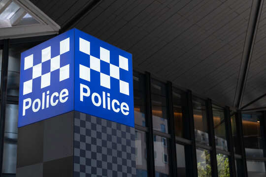 MELBOURNE, AUSTRALIA - FEBRUARY 20 2023: Blue and white 'Police' neon sign in front of a police station in Spencer street in Melbourne, Australia