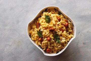 Jada Poha Namkeen Chivda or Thick Pohe Chiwda. Diwali special savory snack, made out of puffed rice, fried peanuts, curry leaves and some spices. Traditional Indian Diwali Snacks. with Copy Space.