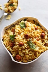 Jada Poha Namkeen Chivda or Thick Pohe Chiwda. Diwali special savory snack, made out of puffed rice, fried peanuts, curry leaves and some spices. Traditional Indian Diwali Snacks. with Copy Space.