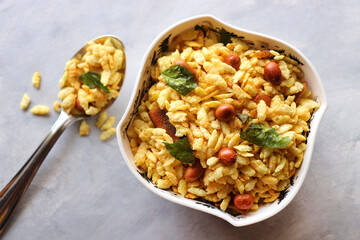 Jada Poha Namkeen Chivda or Thick Pohe Chiwda. Diwali special savory snack, made out of puffed rice, fried peanuts, curry leaves and some spices. Traditional Indian Diwali Snacks. with Copy Space.