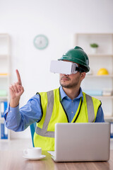 Young male architect wearing virtual glasses