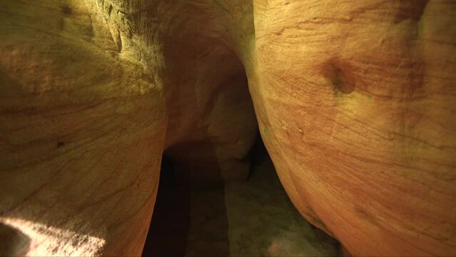 dolly shot of a smooth sandstone, sunlit, cave