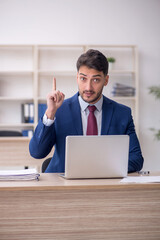 Young male employee working in the office