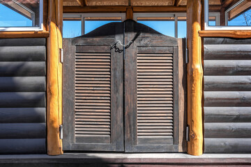 Decorative wooden bar door. Louvered saloon doors