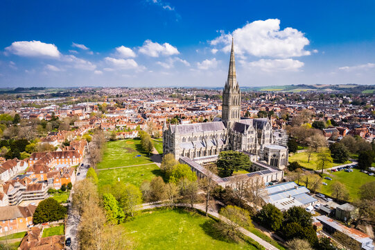 Aerial shot of Salisbury Cathedral under a sunny blue sky
