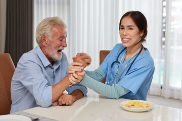 Fototapeta premium Happy caregiver try stopping senior caucasian man eating hamburger or junk food and taking medicine after breakfast in living room at retirement house. Unhealthy and junk food lifestyle concept.