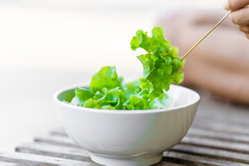 Vegetable salad in white bowl with fork is a healthy food.