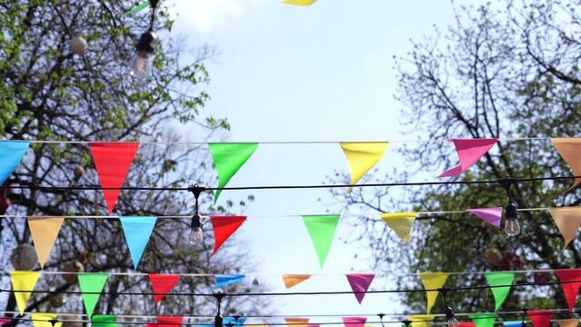 Colorful paper flags over street in the city , holiday