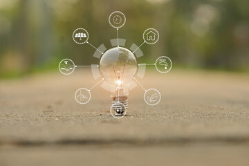 Light bulb Energy saving and a coin glass on the floor nature background