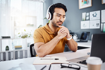 Thinking, laptop and headphones on business man listening to music, audio or webinar. Asian male entrepreneur with technology for planning strategy, idea or reading email or communication on internet