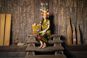 A Borneo lady showcasing the beauty of her culture through her stunning traditional clothing - obrazy, fototapety, plakaty