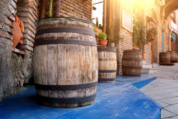 Several wooden vintage barrels for making wine on the street.
