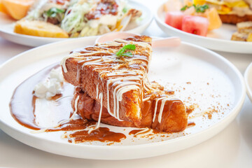 French toast in cream and biscuit topping styled at a fancy cafe.