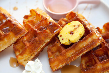Chocolate waffle with dressing of chocolate sauce and strawberry gelato on the side.