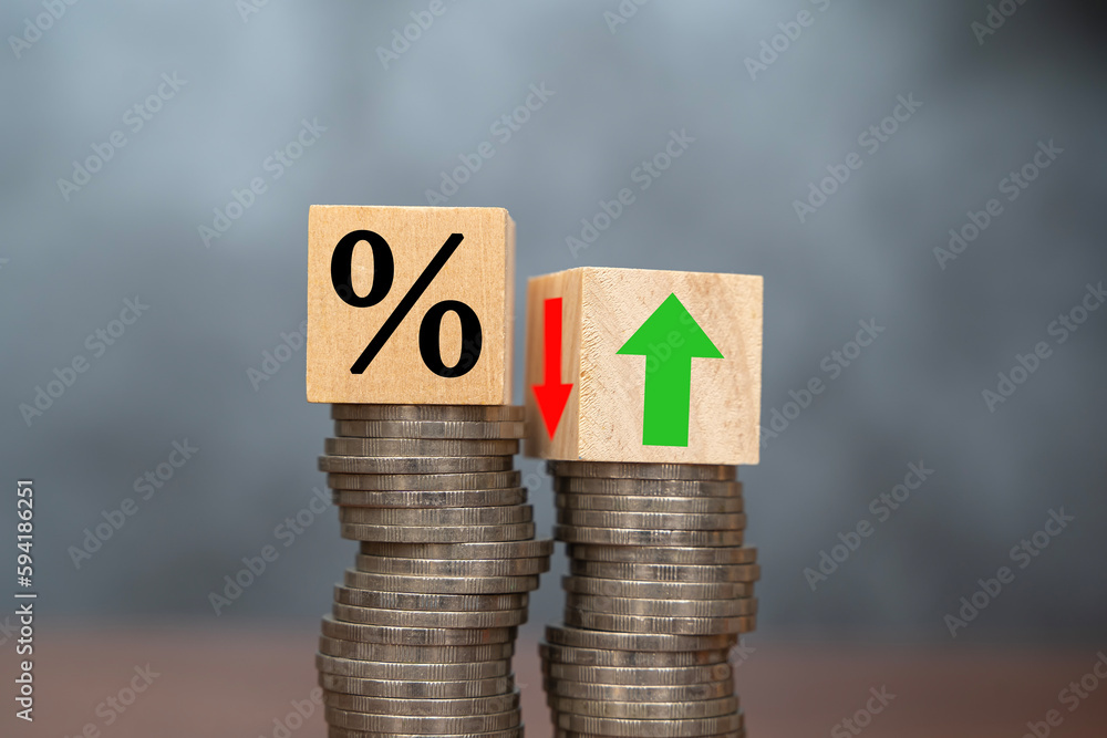 Poster the concept of increasing or decreasing interest rates. wooden cube with percentage icon up and down
