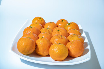 tangerine on a white background. How to choose, store and how much you can eat so as not to harm the body.