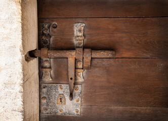 metal antique bolt on the old wooden door