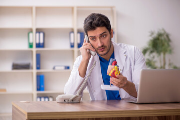 Young male doctor cardiologist working in the clinic