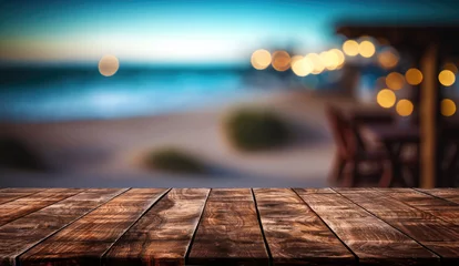 Foto op Plexiglas Donkerbruin Empty wooden table and blurred background of beach cafe with bokeh lights