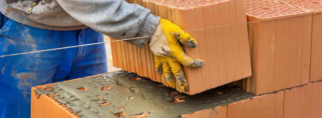 bricklayer at work at new house in construction