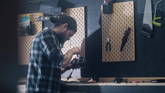 Man restoring old camera at home, diy concept