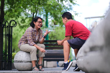 A woman and a man are talking casually in the park