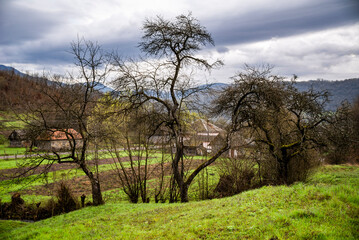 Mountain Village on a Sunny Summer day.Amazing view on a small village on the Mountains .Green valley with fields and villages among mountains.