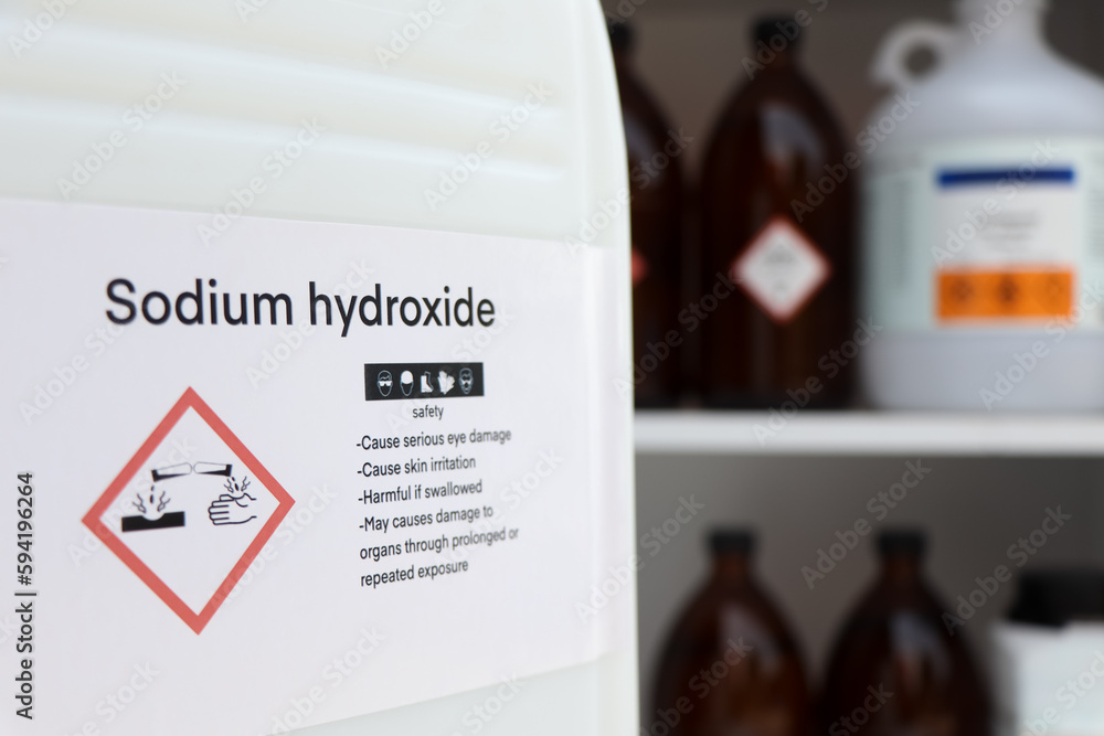 Poster sodium hydroxide, hazardous chemicals and symbols on containers