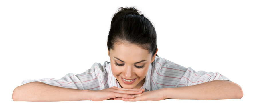Woman with folded arms looking down on a blank surface
