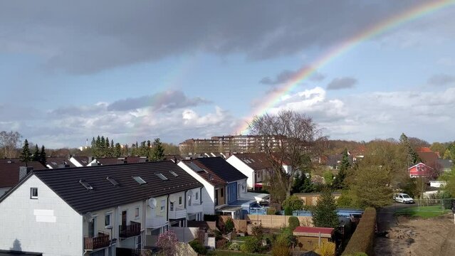 Double rainbow above houses in the city