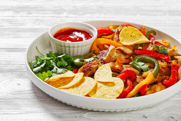 chicken fajitas with peppers, onion, taco chips