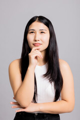 Thoughtful asian beautiful woman with long black hair thning natural mae up welness skincare.