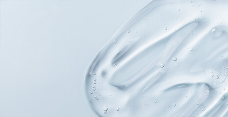 Serum gel smear on blue background. Cosmetic transparent gel serum texture. - 594202661